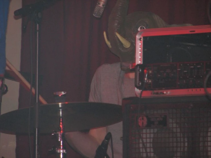 a person with headphones on while looking at a band equipment
