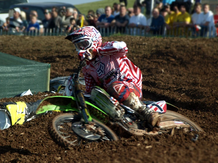 a man riding on the back of a green dirt bike