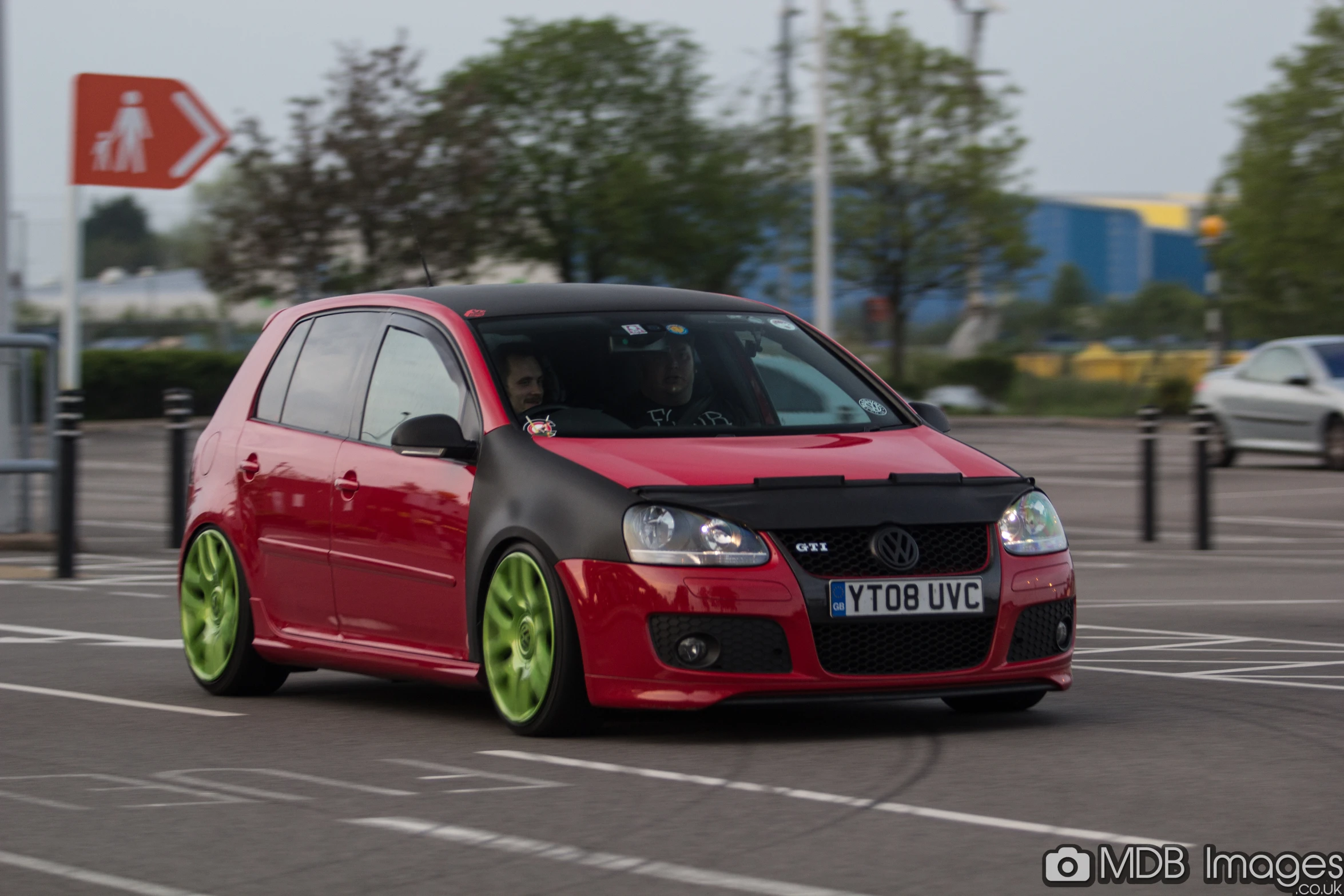 a small car with lime spokes and chrome wheels