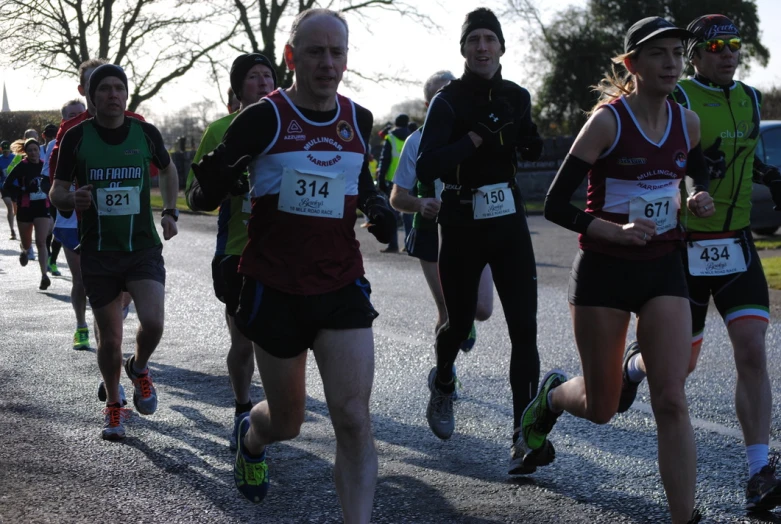 a group of men and women racing through the streets