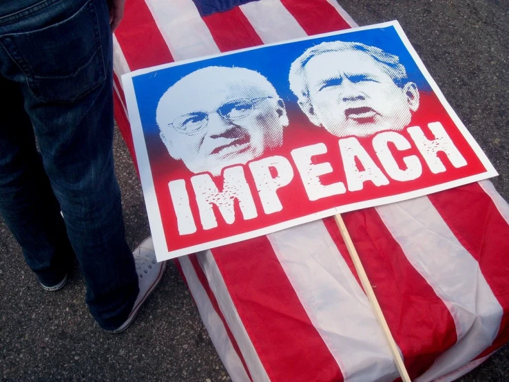 a political banner sitting on top of some luggage