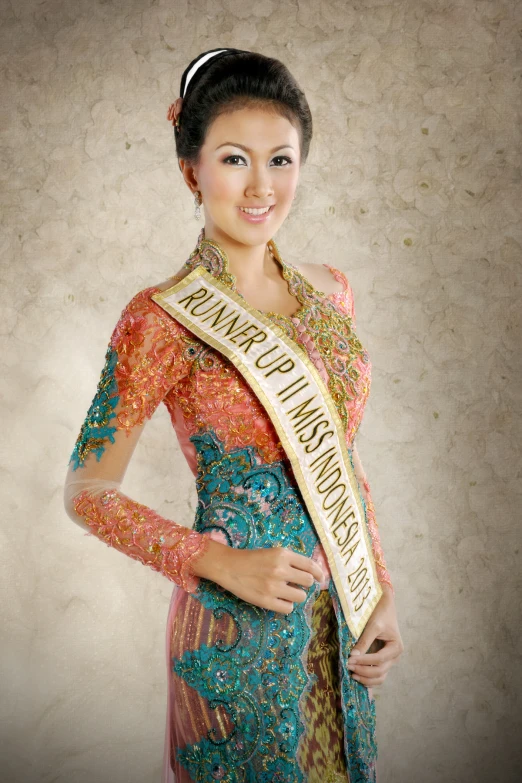 an asian woman with a sash that reads thailand international dress contest