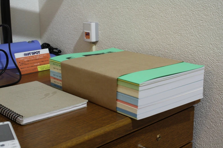 the view of a notepad, folders and calculator on a desk