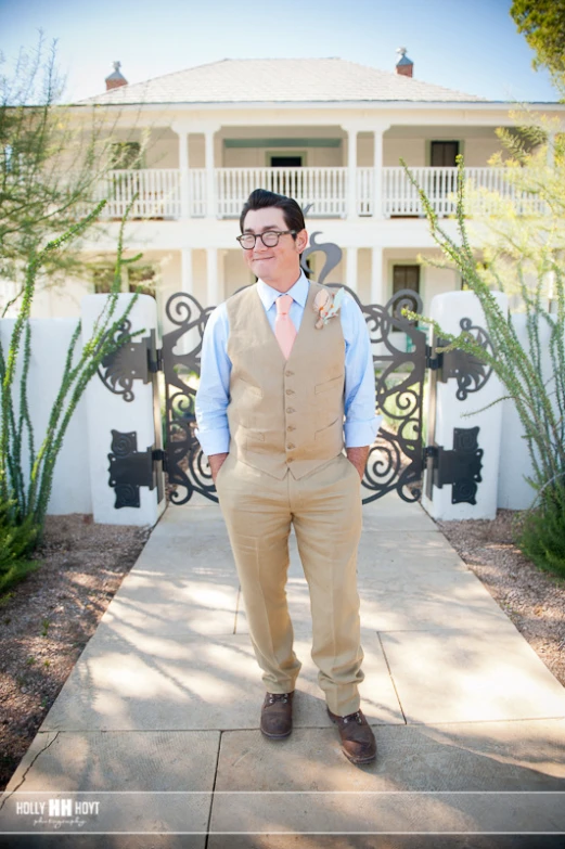 the man is standing outside wearing a suit and tie