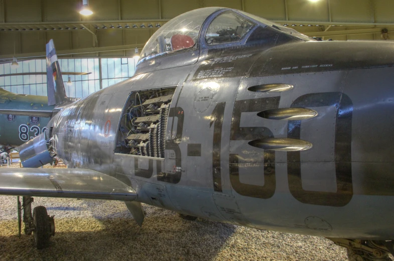 there is a silver fighter plane that has holes in it