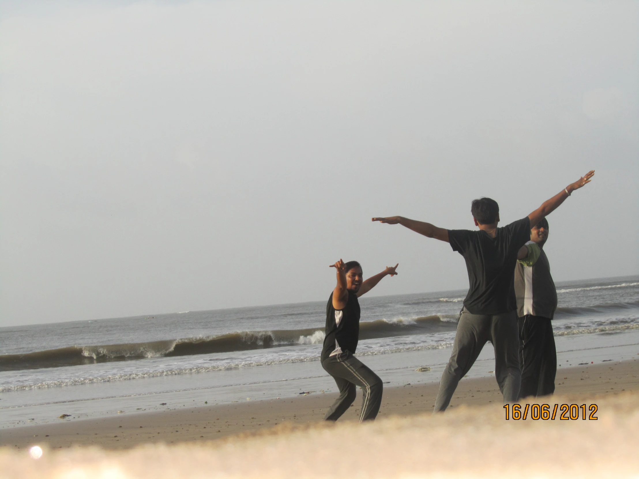 the group is playing with a kite on the beach