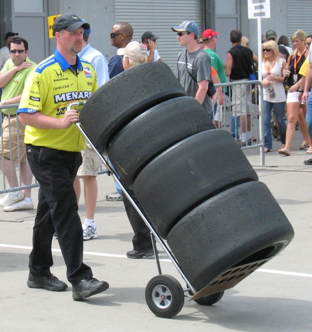 a man is pulling a trailer made of tires