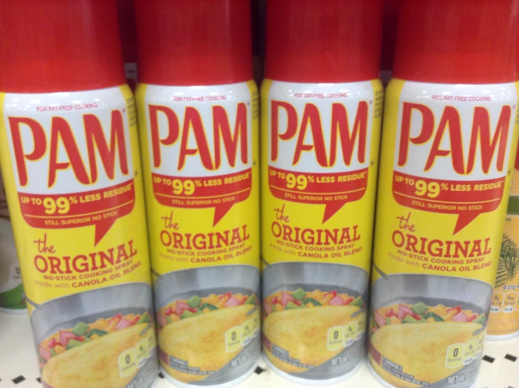 three canisters of original pam are stacked up on a shelf