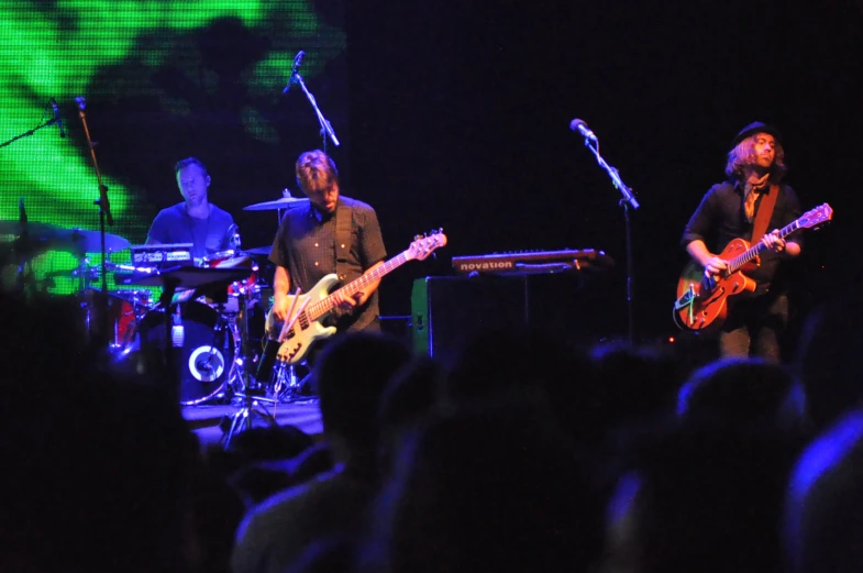 two guitarists playing guitar at an outdoor concert