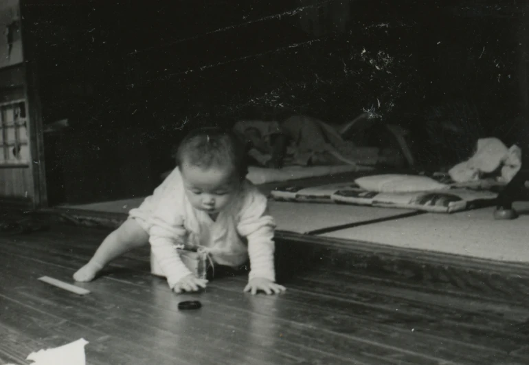 a toddler crawls on the floor in front of the bed