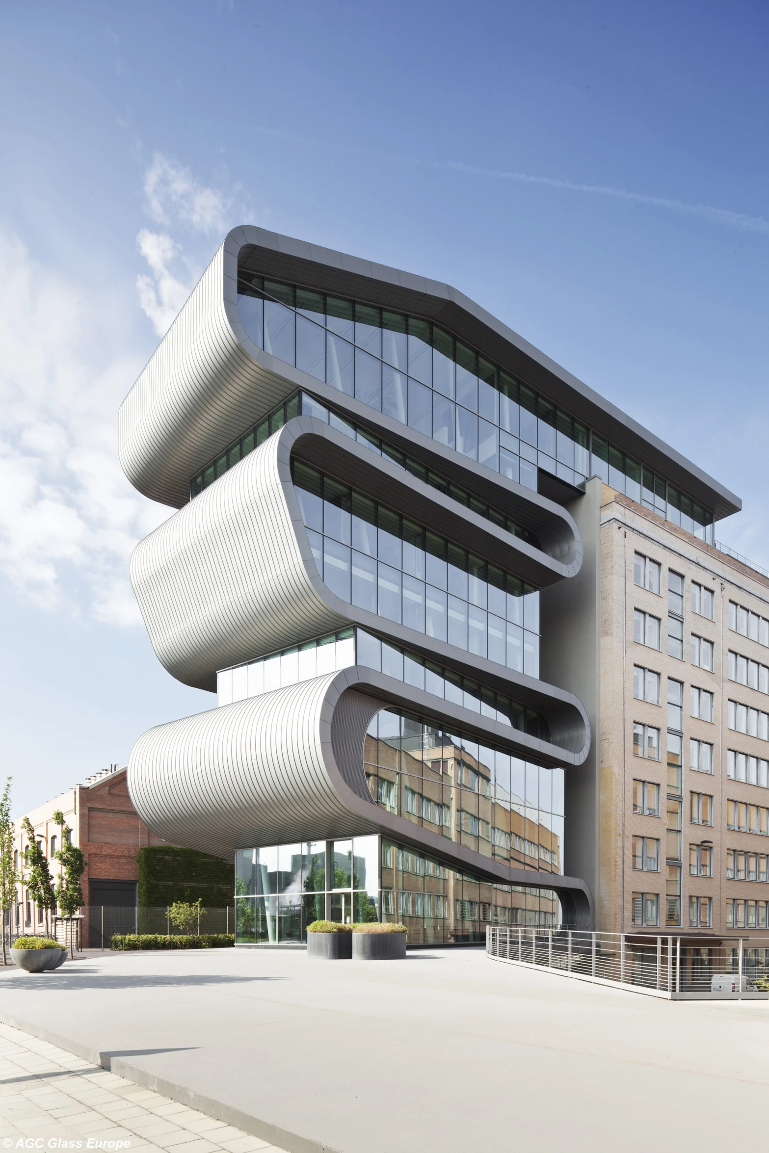 large building with wavy glass face against blue sky