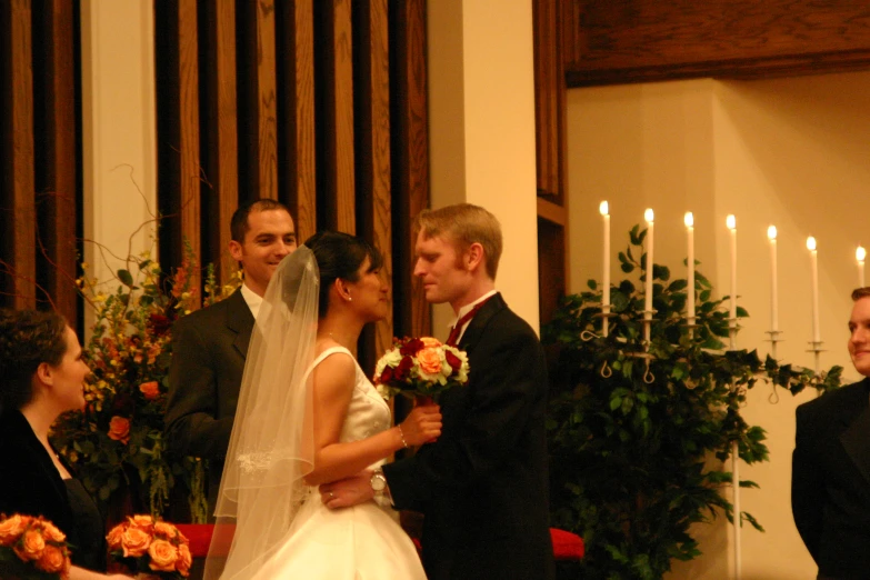 a married couple are standing together at the alter