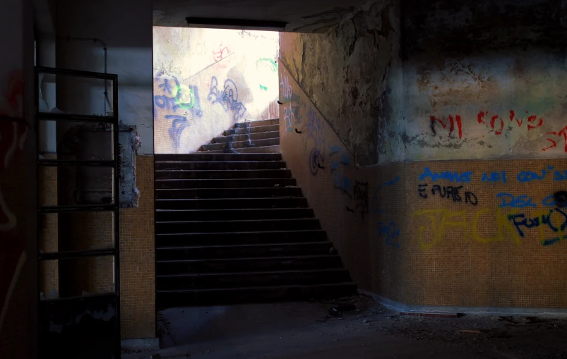 some stairs with graffiti on them and one person walking down the steps