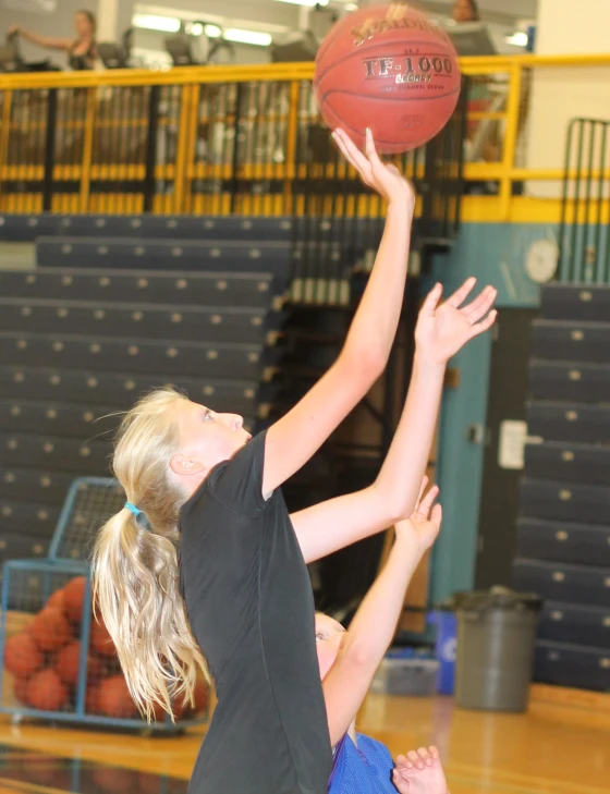 two girls in action on the basketball court