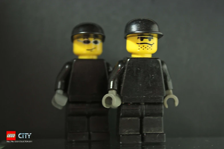 two lego minifigs in a uniform and hat