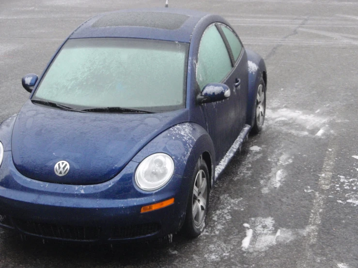 a blue volkswagen beetle parked in a parking lot