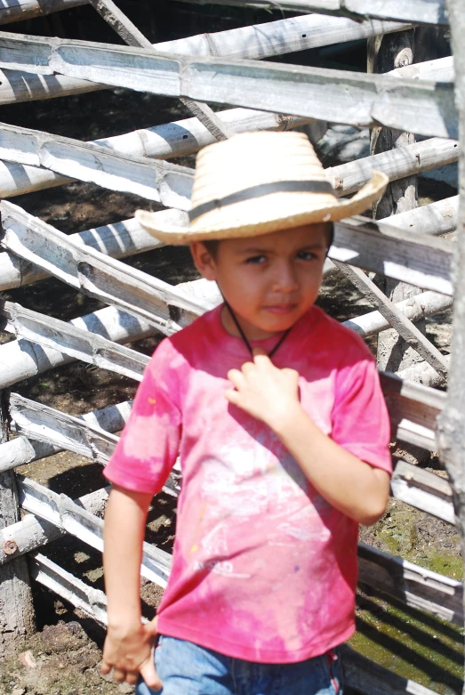 a small boy standing next to a pile of silver objects