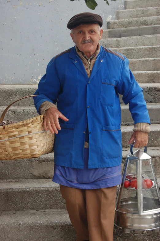 an older man is holding a large basket