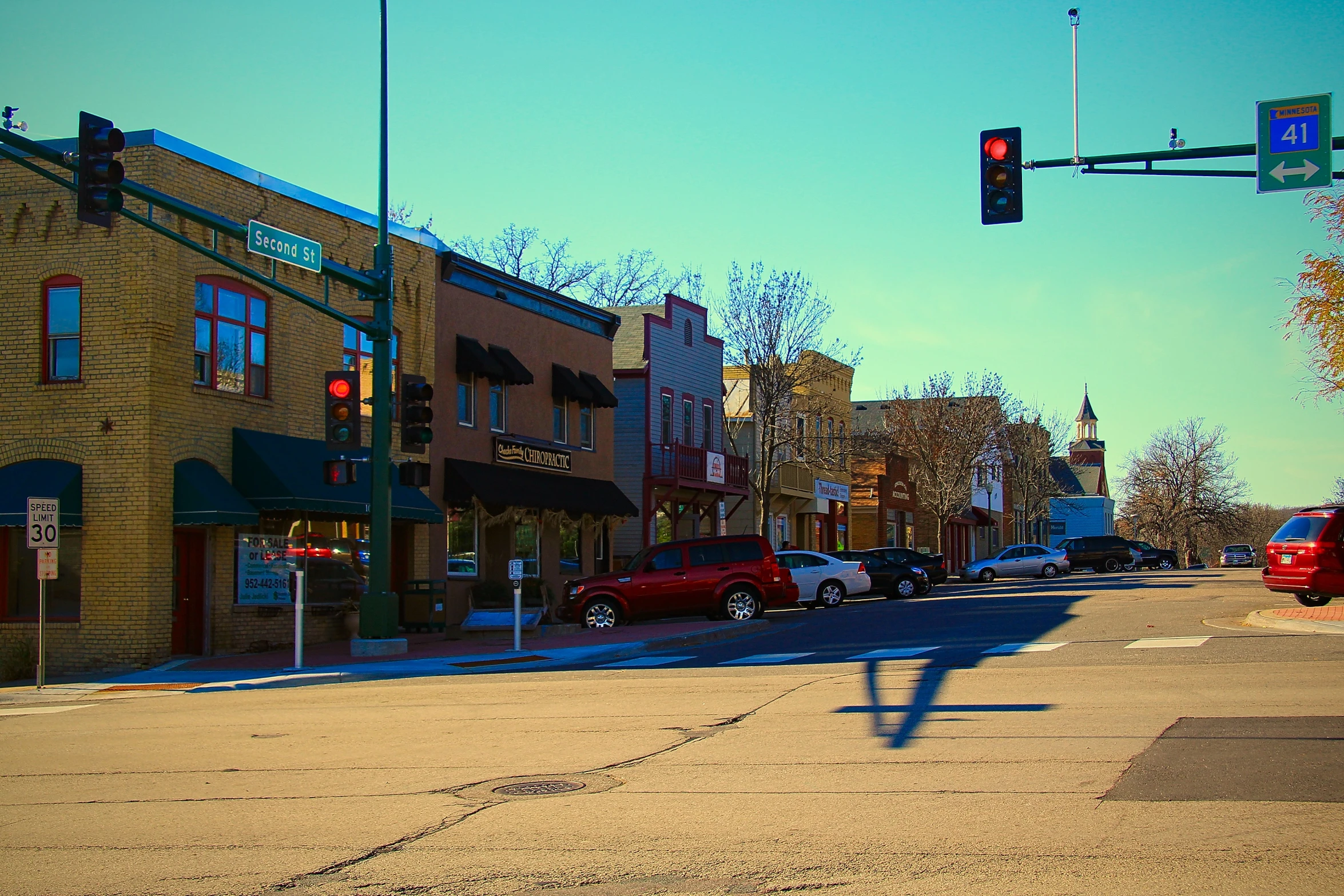 a red traffic light sitting over a street