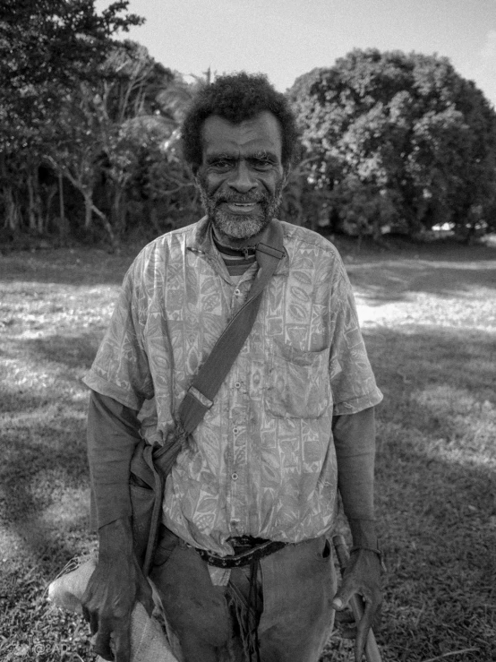 a man in a shirt holding a walking stick