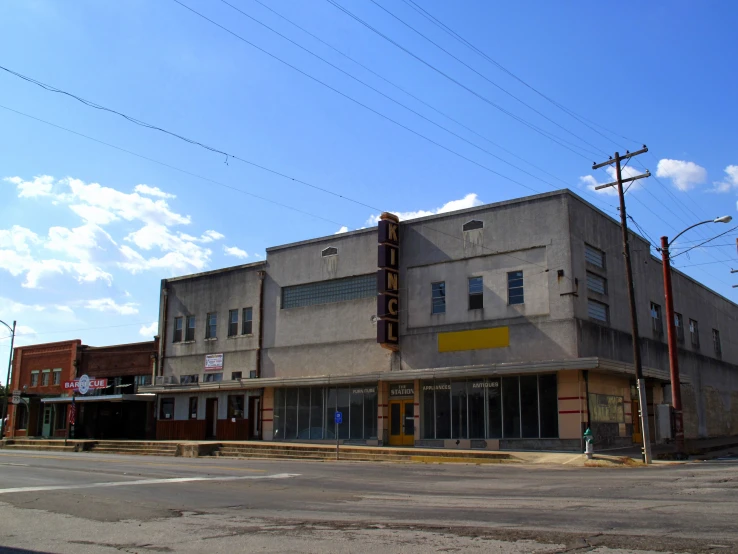 a corner storefront with an odd yellow sign