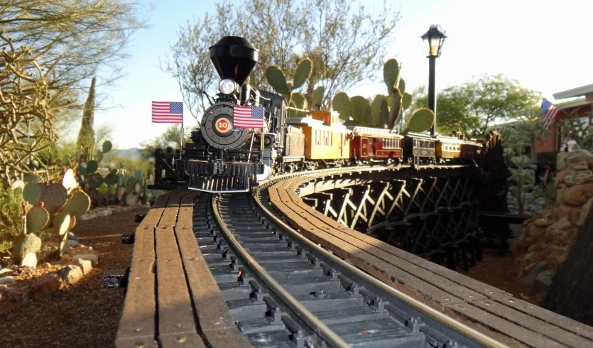 a toy train travels on a track in a museum setting