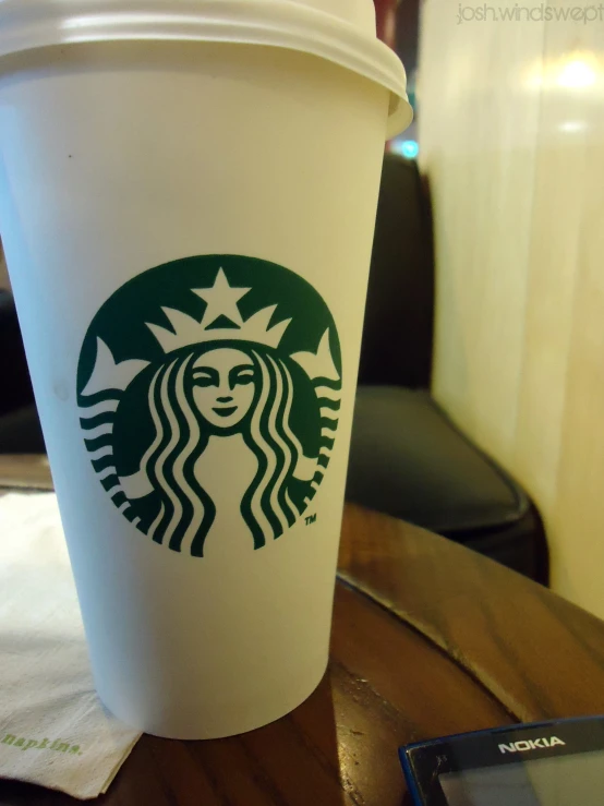 a starbucks cup sitting on top of a table