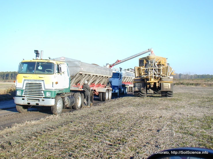 the semi truck has a crane on its trailer