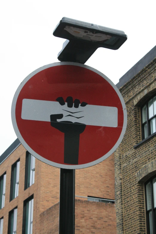 a red and white street sign hanging on top of a metal pole