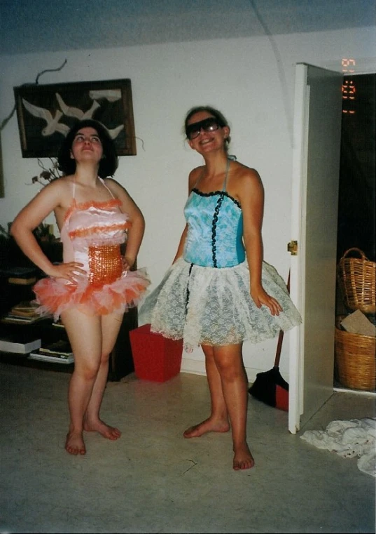 two women standing on the side walk in a house