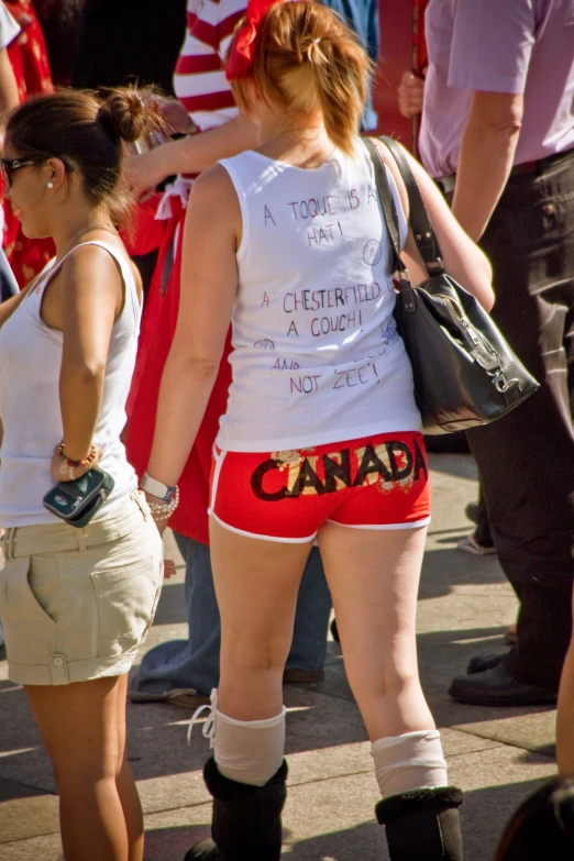 a man in red and white underwear standing next to another person