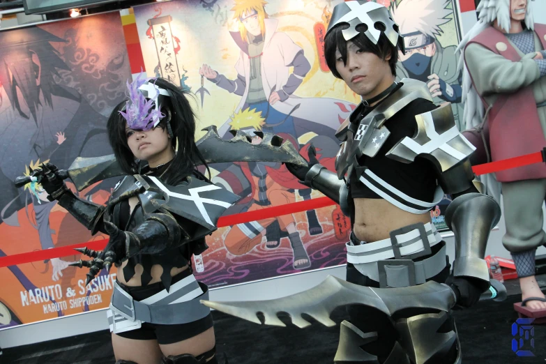 two cosplay posing for the camera with one girl dressed in a costume