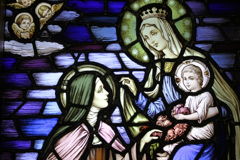 a stained glass window depicting the holy virgin mary and child jesus