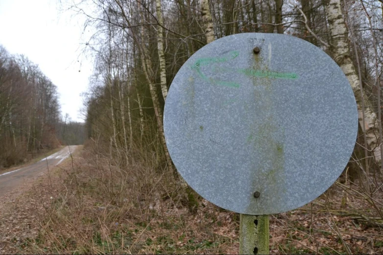 a sign is displayed on the side of the road