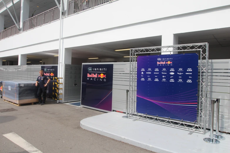 people standing around and looking at some posters on display