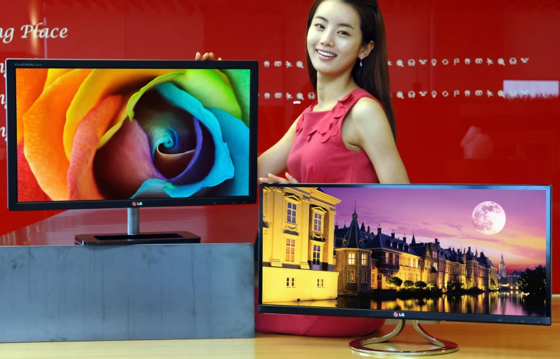 a woman holding up two samsung electronics devices