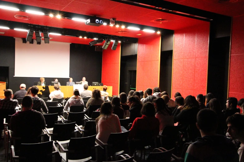 the audience at the conference is watching a presenter