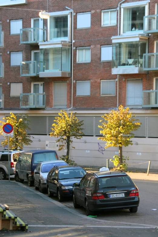 cars parked in a parking lot near apartment buildings