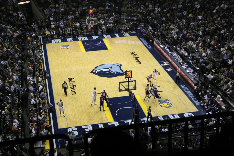 a po of a basketball game in a stadium with many fans