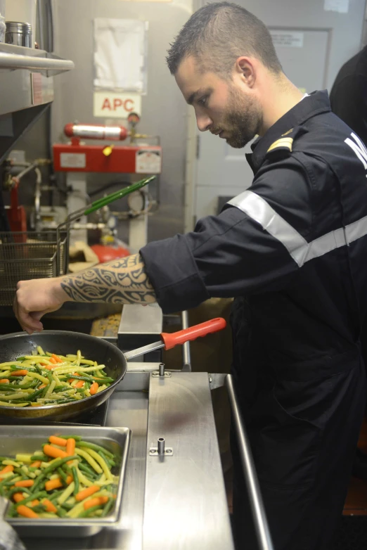 a man is cooking vegetables in a restaurant kitchen