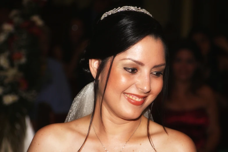 a bride is standing before a crowd at the wedding