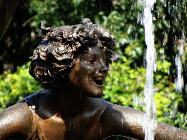 a bronze statue with hair coming out of it