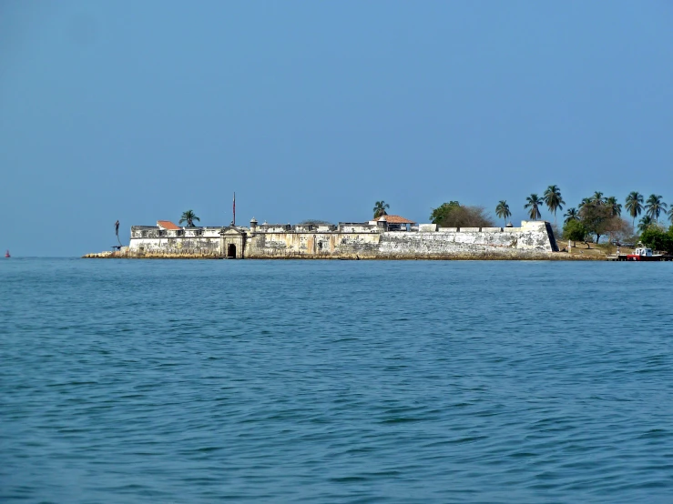 a city with a lot of small buildings sitting in the middle of water