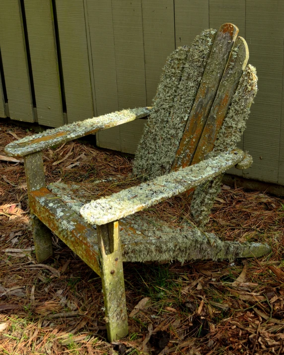 a broken old chair sitting next to a building