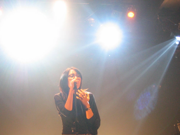 a woman in black shirt and shorts holding a microphone