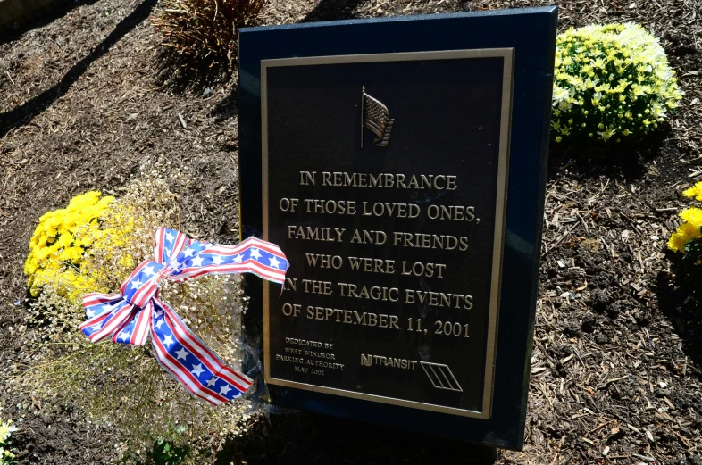 a memorial marker with a bow on top