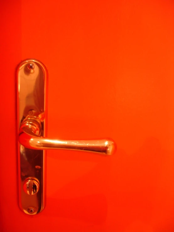 an orange background with a door handle on it