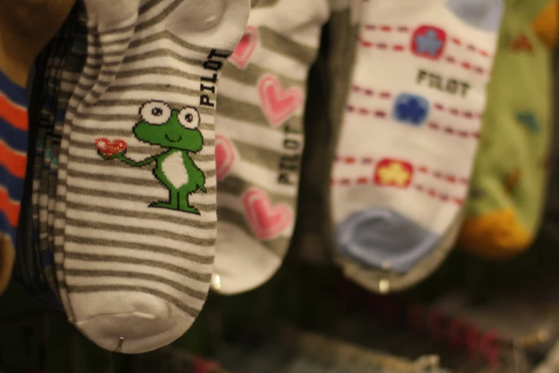 baby socks with frog cartoon printed on them