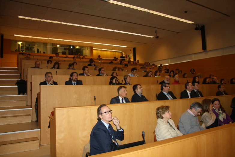 a room filled with people sitting in chairs