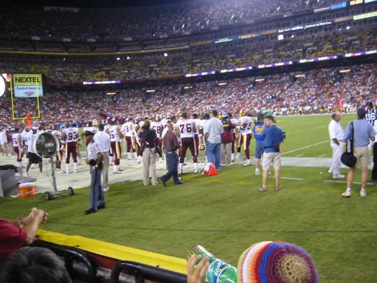 a group of men standing on top of a football field